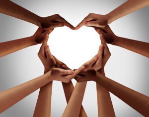 Heart hands as a group of diverse people hands connected together shaped as a love symbol expressing the feeling of being happy and togetherness.