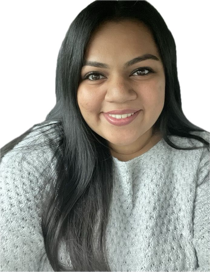 Woman with long dark hair smiling, wearing a gray sweater.