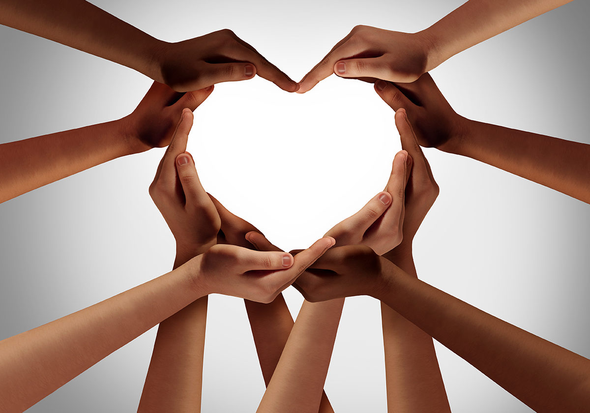 Heart hands as a group of diverse people hands connected together shaped as a love symbol expressing the feeling of being happy and togetherness.